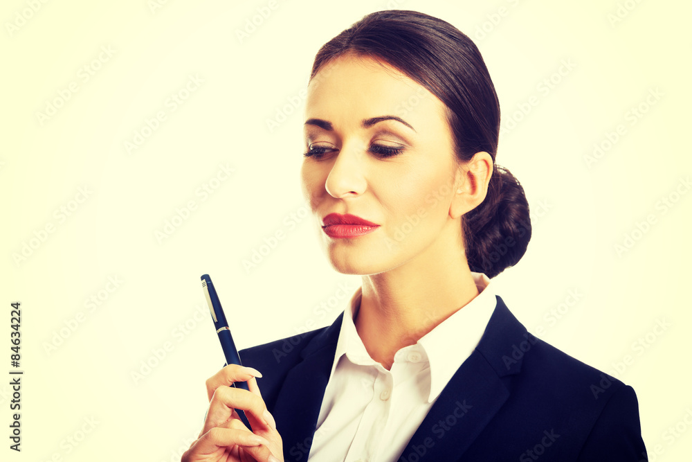 Portrait of thoughtful businesswoman holding a pen Portrait of thoughtful businesswoman holding a pen