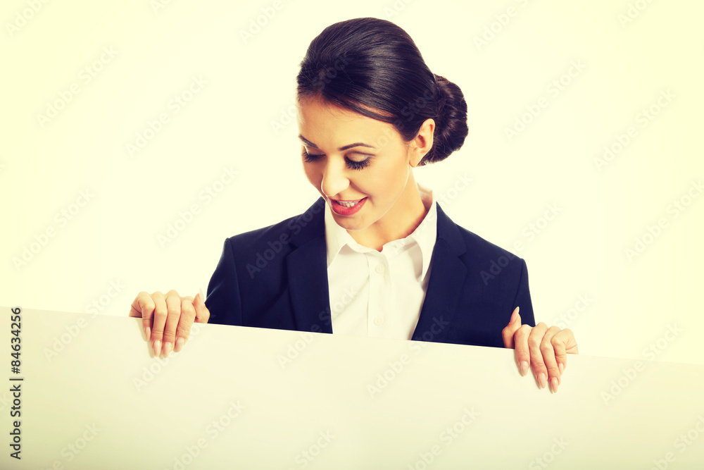 Portrait of businesswoman holding white banner Portrait of businesswoman holding white banner