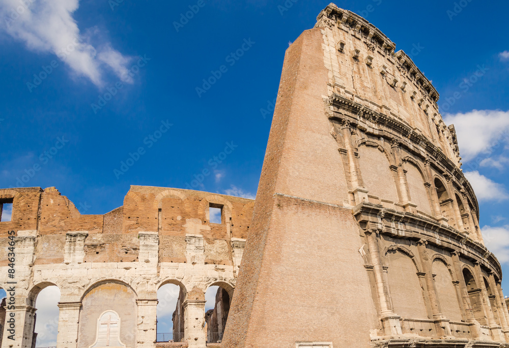  rear view of the colosseum, one of the most important Heritage site from Roman empire, during a sunny day. Rome