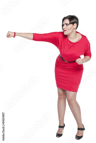 Beautiful plus size woman in red dress beating something isolate