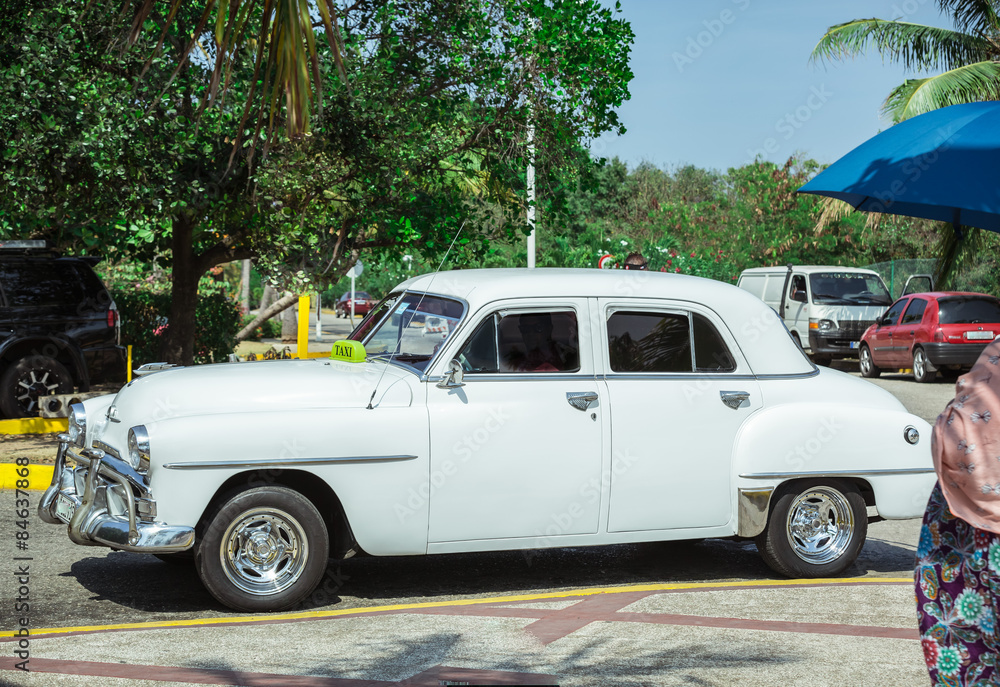  Old vintage classic car standing on the road in tropical garden