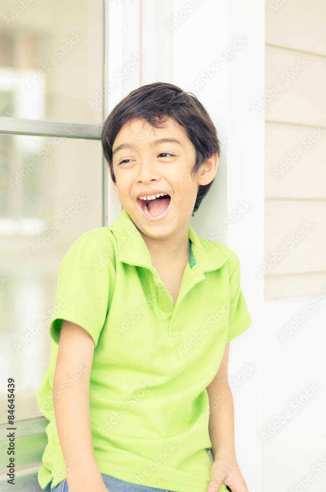 Little boy sitting at the window with happy face Little boy sitting at the window with happy face