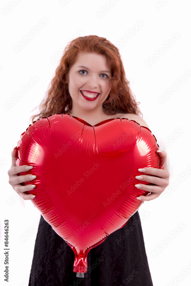 Close up view of a happy young girl holding a red balloon. Close up view of a happy young girl holding a red balloon.