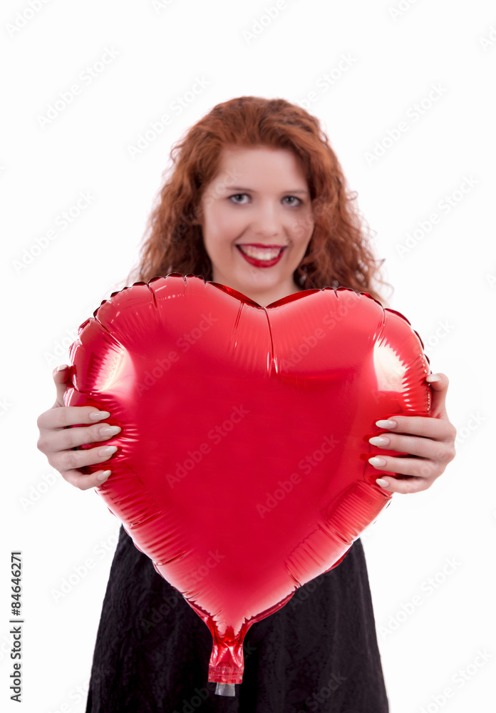Close up view of a happy young girl holding a red balloon. Close up view of a happy young girl holding a red balloon.