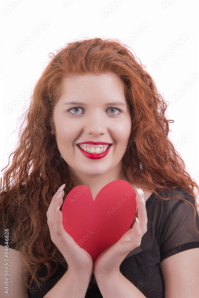 Close up view of a happy young girl with a red heart. Close up view of a happy young girl with a red heart.