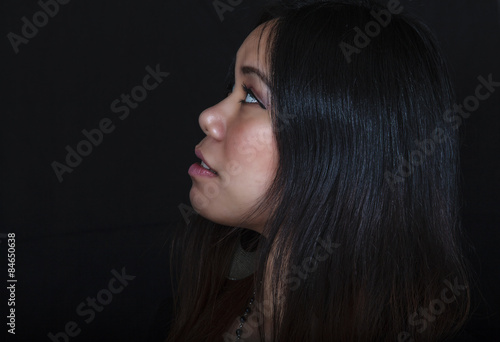 Young Asian Woman Gazing Into the Distance photo