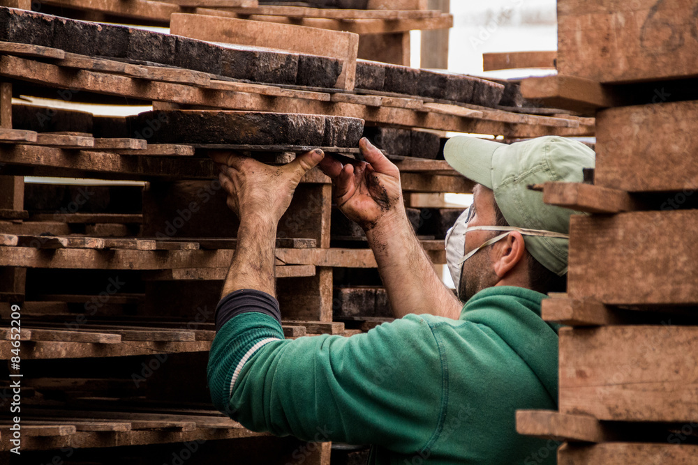Fototapeta premium SAO BRAS DE ALPORTEL, PORTUGAL - April, 2015: View of a bed of traditional mud brick production factory.