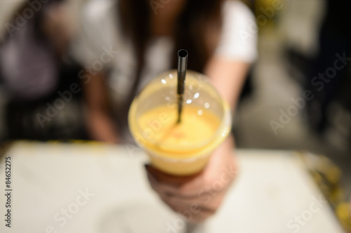 woman holding smoothie