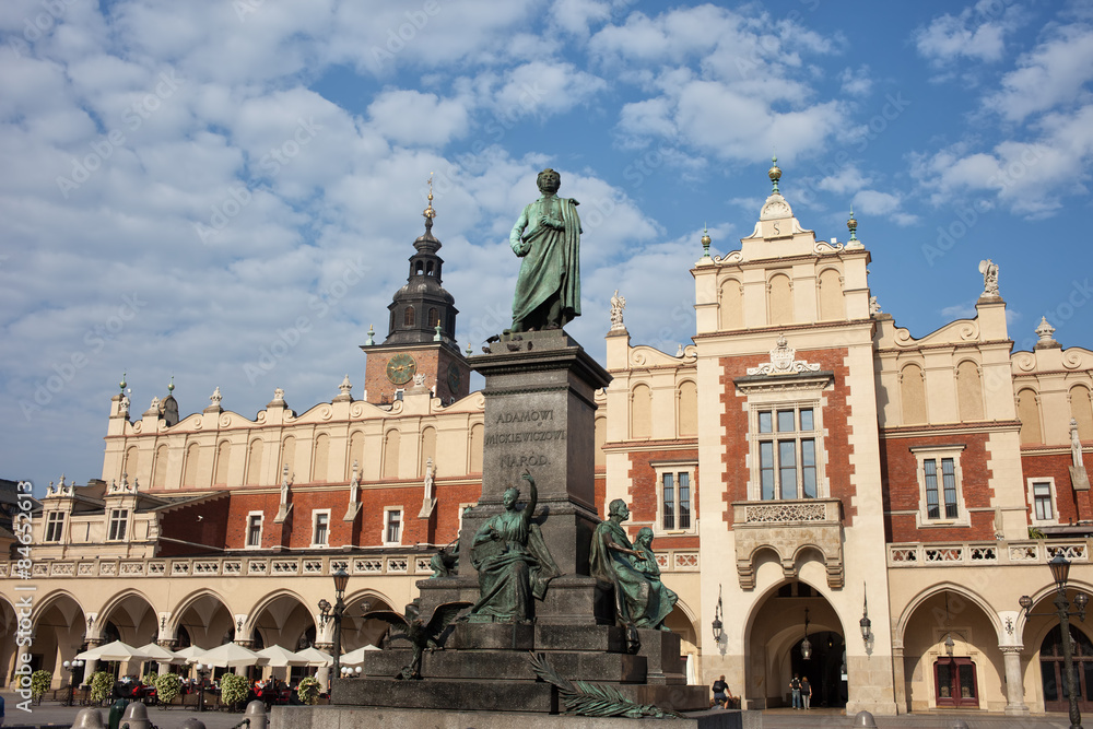 Naklejka premium Adam Mickiewicz Monument and Sukiennice in Krakow