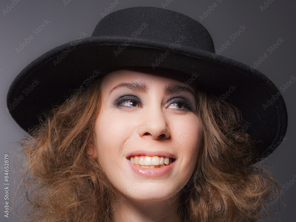 Elegant young lady wearing a black hat Elegant young lady wearing a black hat