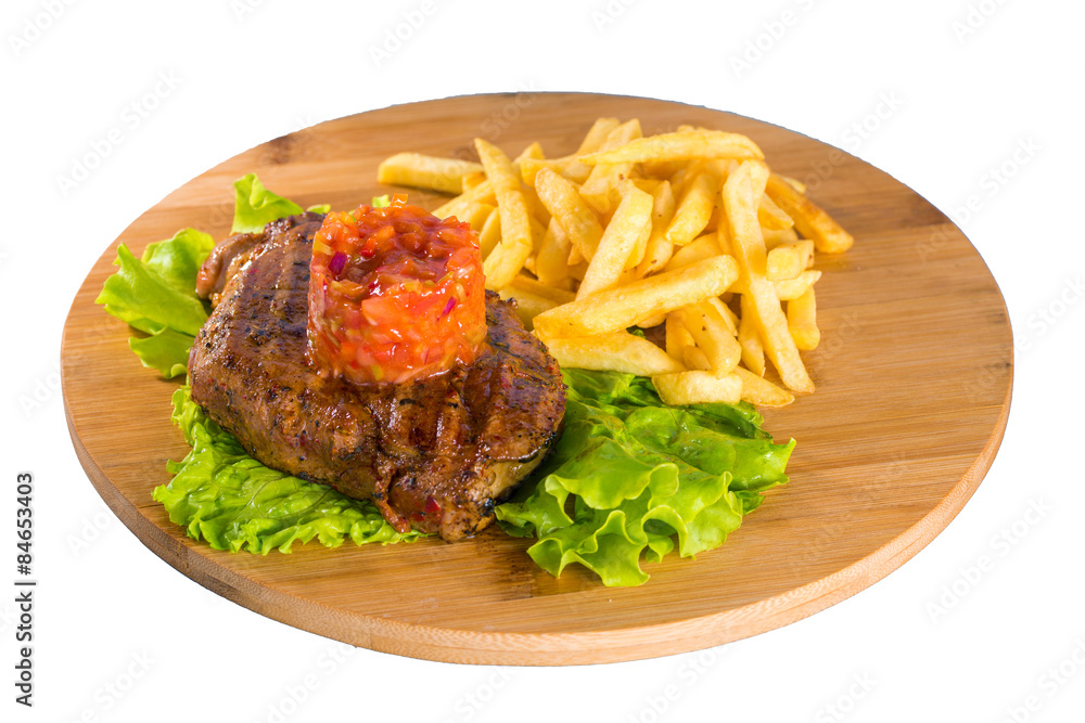 Grilled steak, french fries and lettuce

