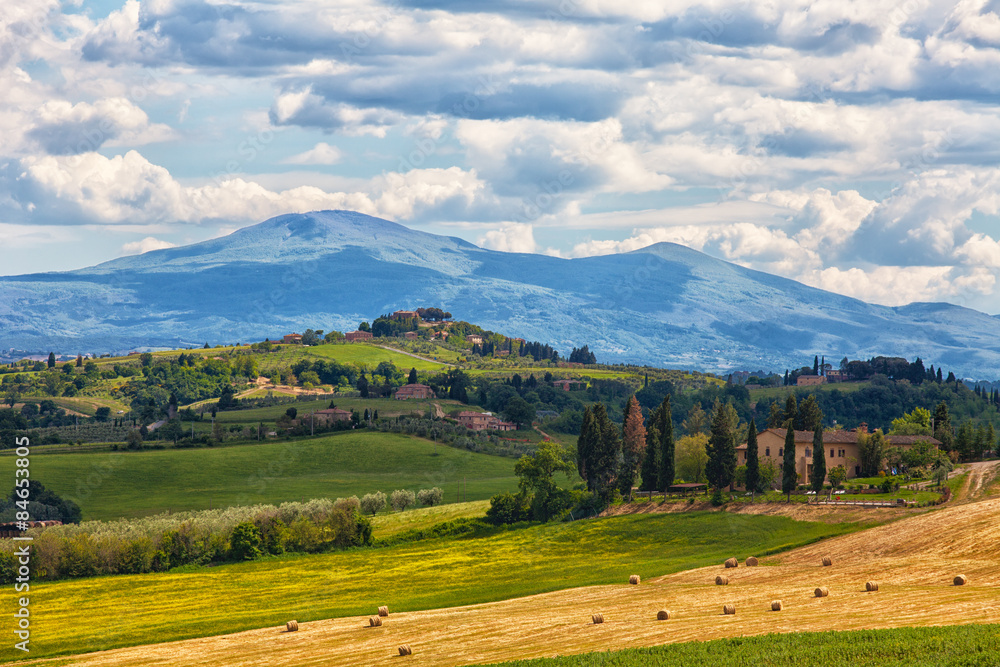 Typical summer rural landscape of Tuscany with hay rolls in the field, Italy