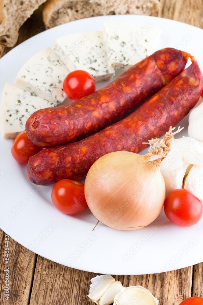 Two pork smoked sausages on white plate Two pork smoked sausages on white plate