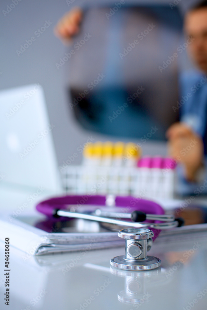 Medical doctor sitting at table and looking patients roentgen Medical doctor sitting at table and looking patients roentgen