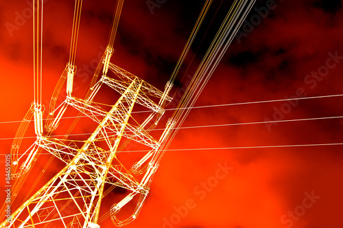 Yellow power tower against orange sky