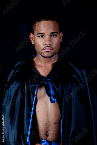 Black man in black and blue cape