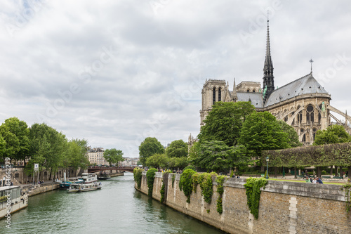 Tourists around the Notre Dame cathedral along river Seine in Paris