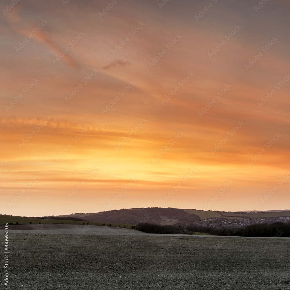 Stunning beautiful sunset over farm landscape with vibrant coors Stunning beautiful sunset over farm landscape with vibrant coors