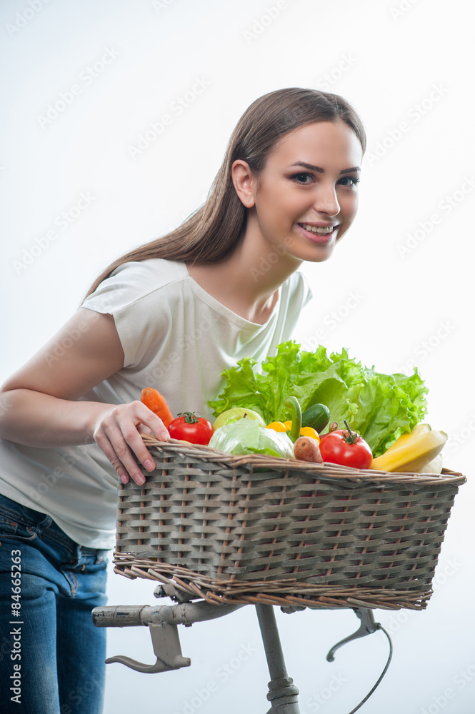 Pretty woman is standing with vegetarian food Pretty woman is standing with vegetarian food