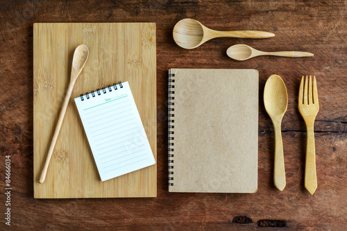 notebook and wooden utensil on old wood