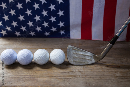 Golf balls with flag of USA on wood table
