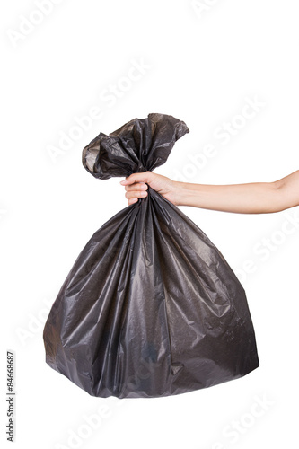 Fényképezés Hand holding black bag of rubbish on white background