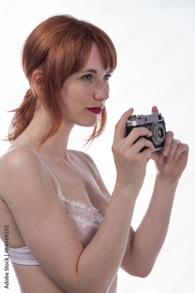 Portrait of young woman taking a photo using an old camera Portrait of young woman taking a photo using an old camera