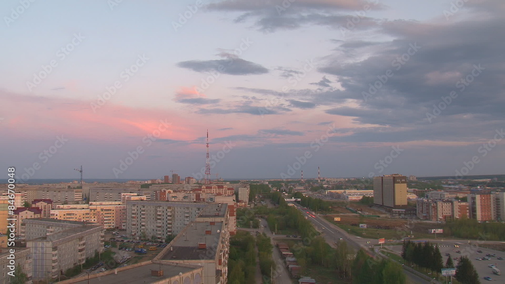 City under the night sky/Above the town night moving clouds. View of the city from above. On the way to go fast cars. Time lapse City under the night sky/Above the town night moving clouds. View of the city from above. On the way to go fast cars. Time lapse