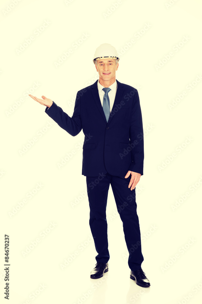 Businessman with hard hat holding copyspace Businessman with hard hat holding copyspace