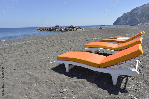 beds on beach Kamari Santorini, Greece