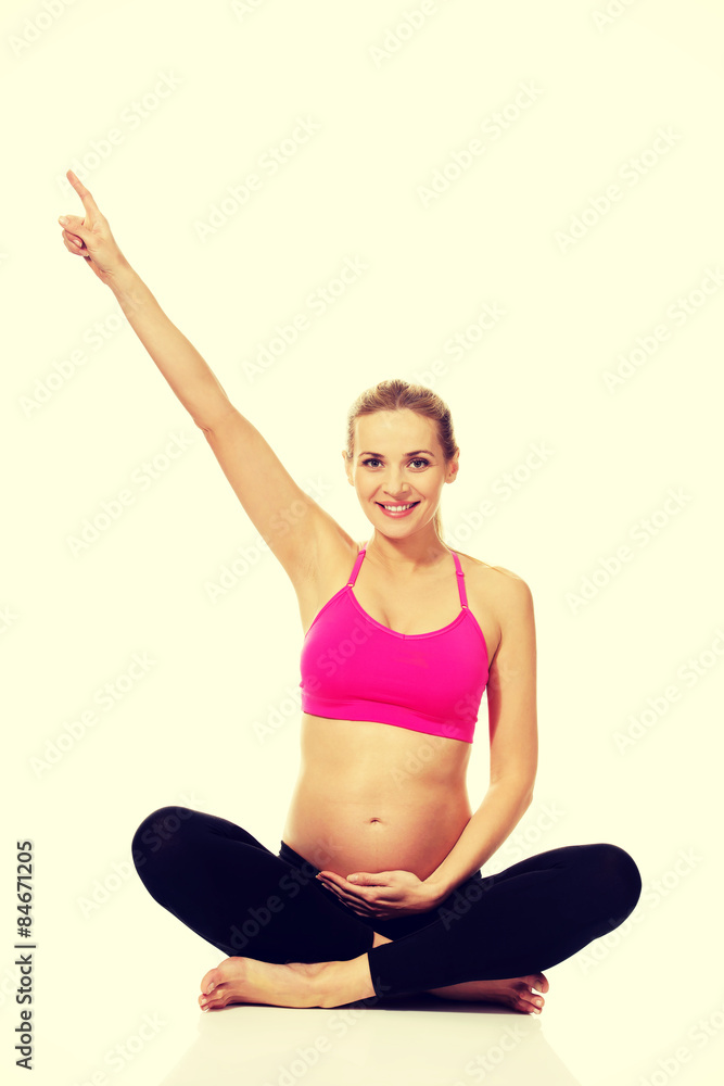 Pregnant woman sitting cross legged Pregnant woman sitting cross legged