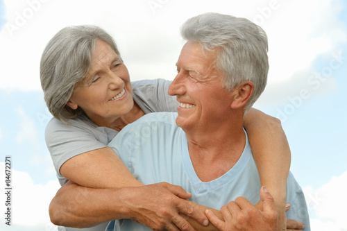 Senior couple on sky background