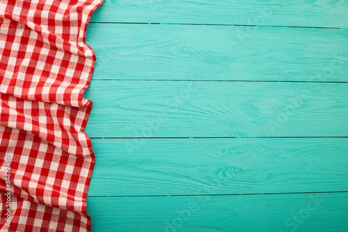 Plaid tablecloth on blue wooden background