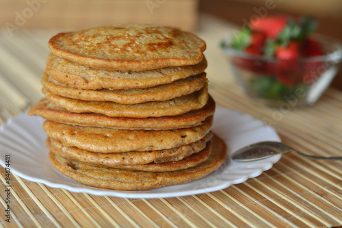 Stack of sweet pancakes with strawberries and cinnamon 