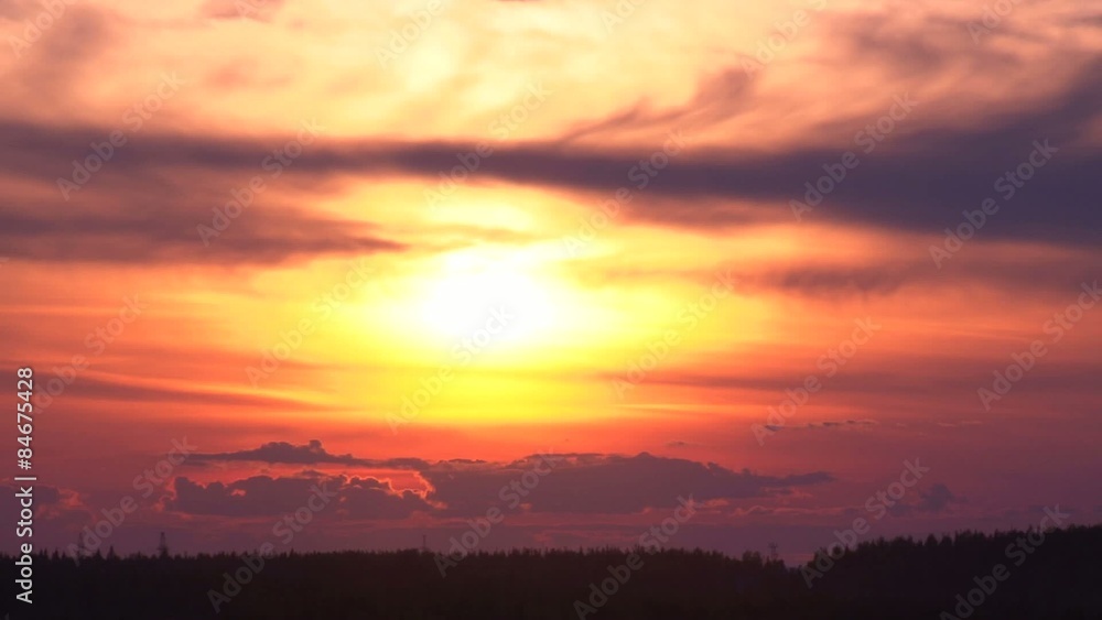The clouds in the sky and the sunset/Red sunset and clouds. The sun and clouds move quickly over the forest. Time lapse The clouds in the sky and the sunset/Red sunset and clouds. The sun and clouds move quickly over the forest. Time lapse