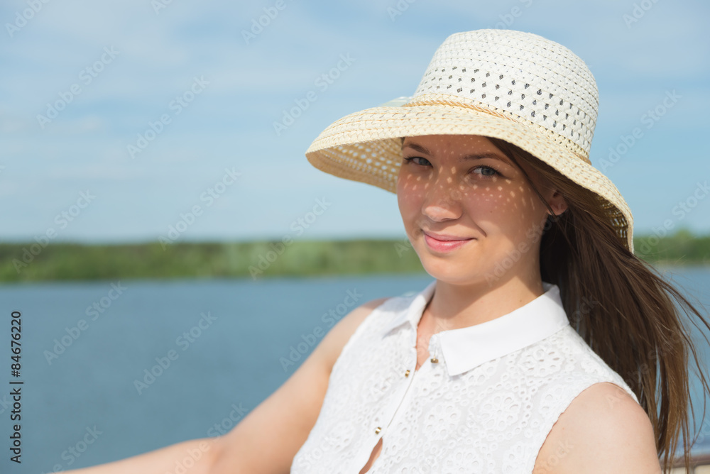 Young girl wearing a straw hat