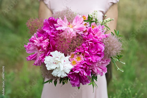 Bouquet in hands. Bride's bouquet