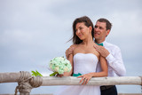 Bride and groom together on a wharf