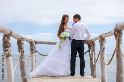 Bride and groom together on a wharf