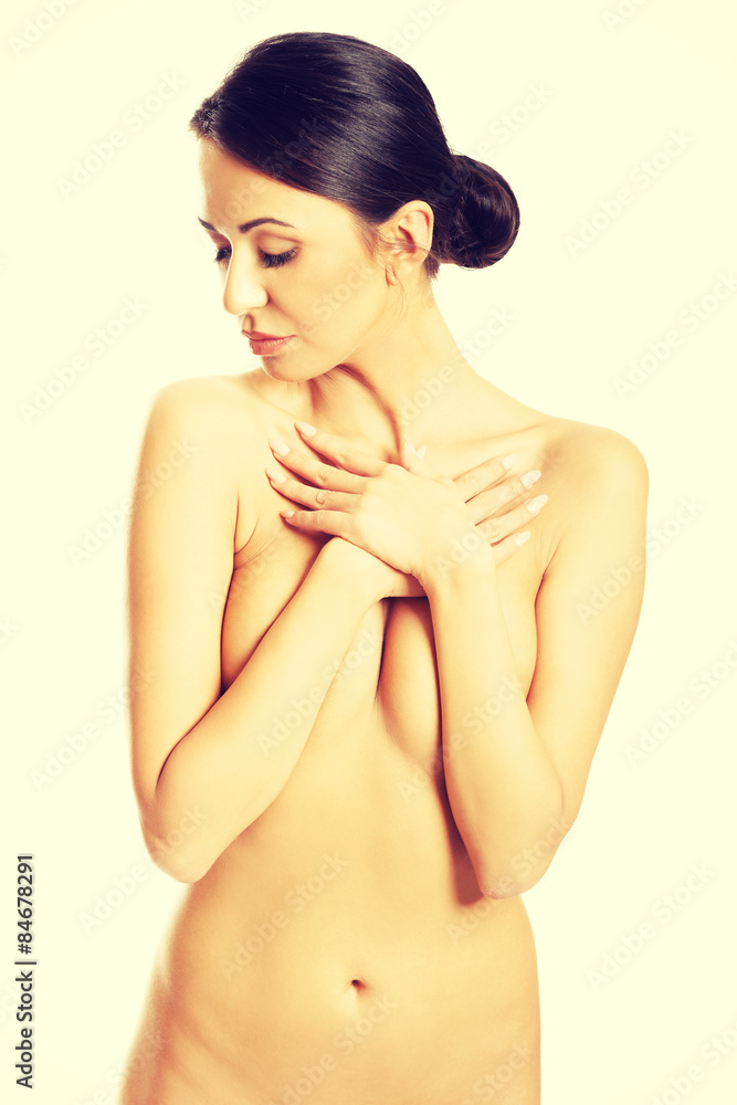 Fototapeta premium Front view of nude woman crossing her arms on chest