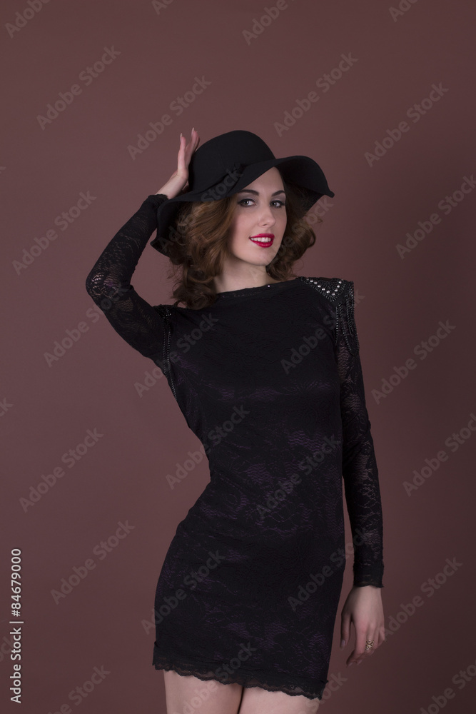 beautiful brunette in a black dress and hat beautiful brunette in a black dress and hat