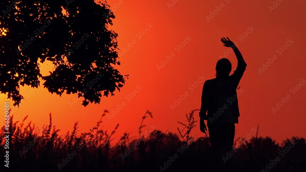 Lonely Man in Countryside Outdoors Walking in Sunset and Waving to PAssing Cars, Silhouettes and Shadows in Beautiful Nature Scenery Lonely Man in Countryside Outdoors Walking in Sunset and Waving to PAssing Cars, Silhouettes and Shadows in Beautiful Nature Scenery