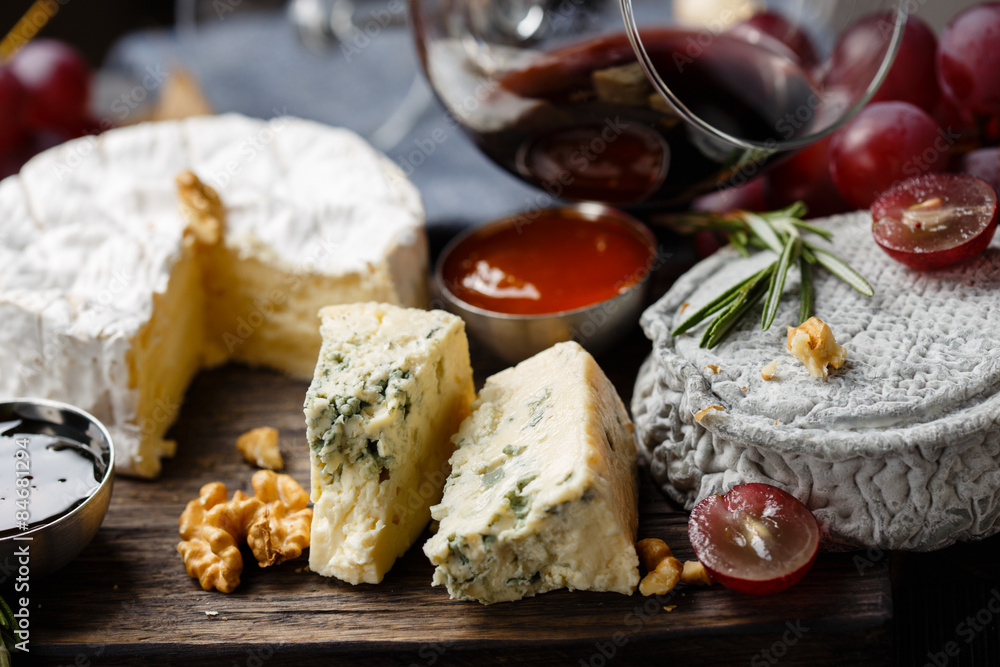 Cheese plate served with wine, jam and honey Cheese plate served with wine, jam and honey