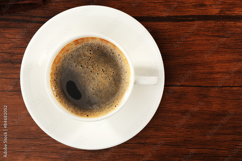 Fototapeta premium Cup of fresh coffee on wooden table, top view