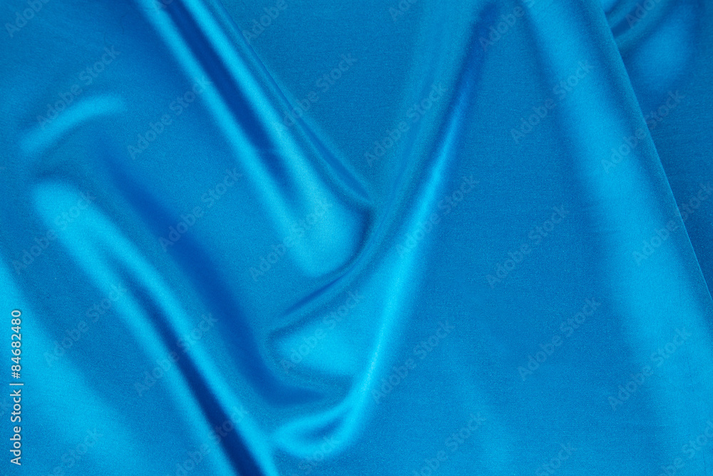 Obraz premium Folds of blue silk cloth texture.