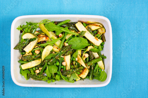 Asparagus, courgette and hazelnut salad in a rectangular dish fr