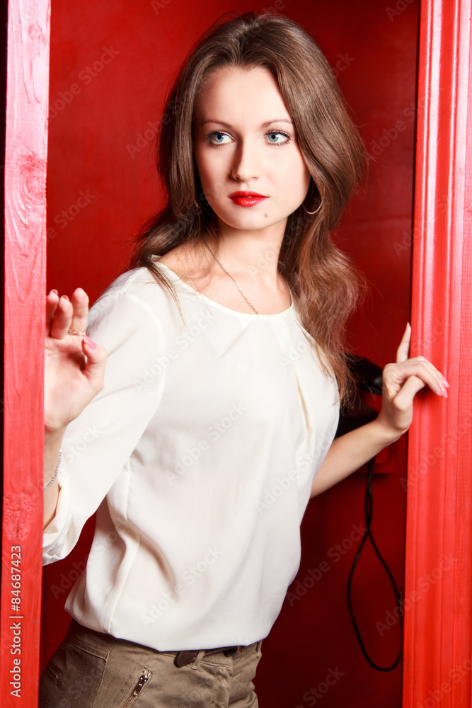 Beautiful girl in an old red telephone box Beautiful girl in an old red telephone box