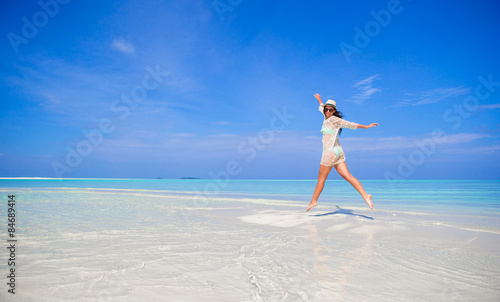 Fototapeta Naklejka Na Ścianę i Meble -  Young girl having fun on tropical white  beach 