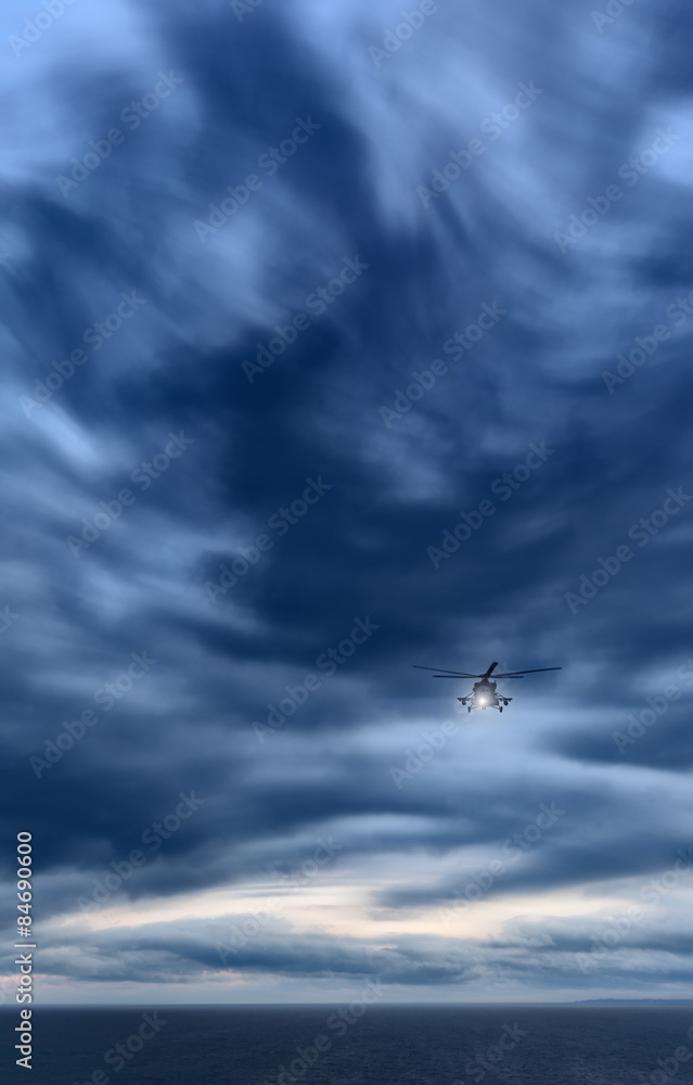 Storm at sea, Mi-8 helicopter from below in front dramatic sky,