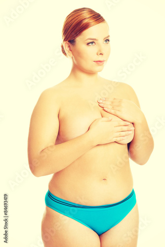 Fat woman covering her breast